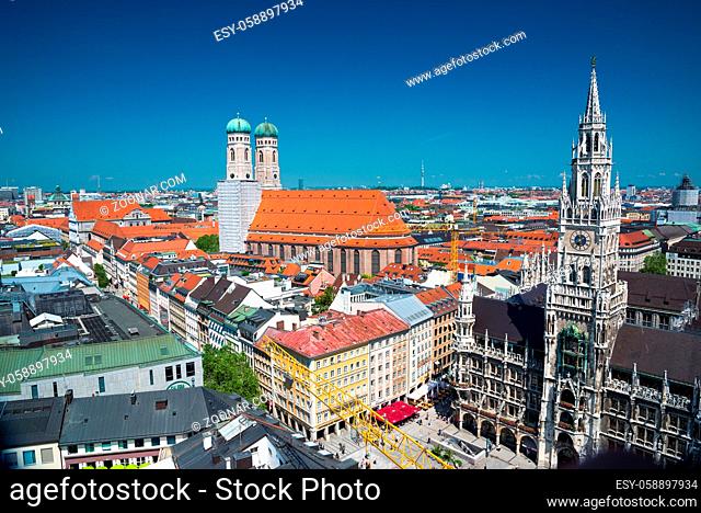 Munich, Germany - June 7, 2016: City view with sky, Frauenkirche, red roofs in Munich near Marienplatz, Bavaria, Germany