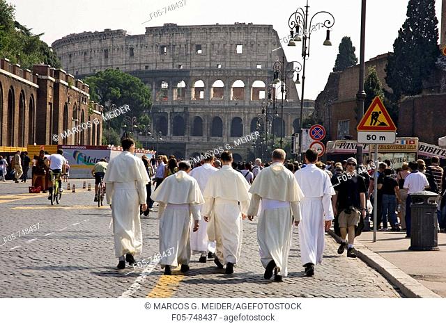 Monks walking through the streets of Rome  The Colosseum in the background  Lazio, Rome, Italy