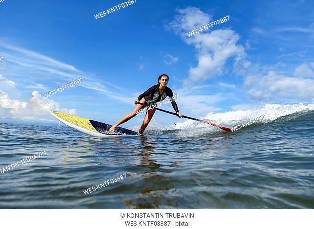 Female SUP surfer, Bali, Indonesia