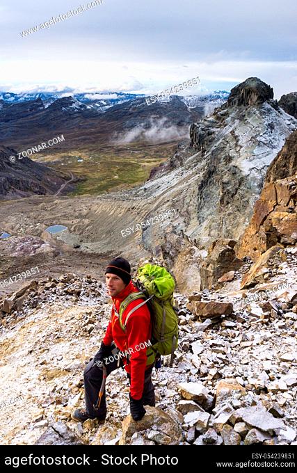 mountain climber on a rocky slope in the Andes of Peru on his way to a remote summit in the Cordillera Blanca