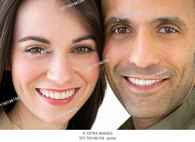Studio portrait of couple smiling
