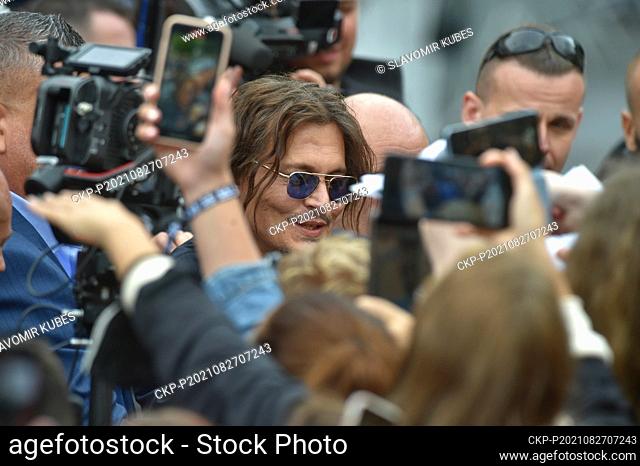 U.S. actor Johnny Depp, center, greets viewers after projection at 55th Karlovy Vary International Film Festival (KVIFF), on August 27, 2021, in Karlovy Vary