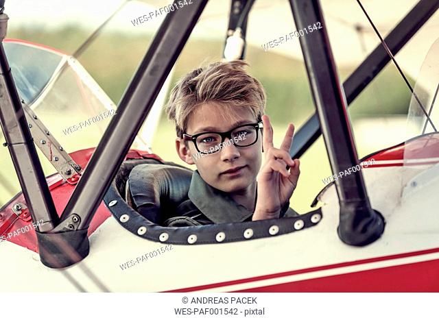 Germany, Dierdorf, Boy sitting in biplane