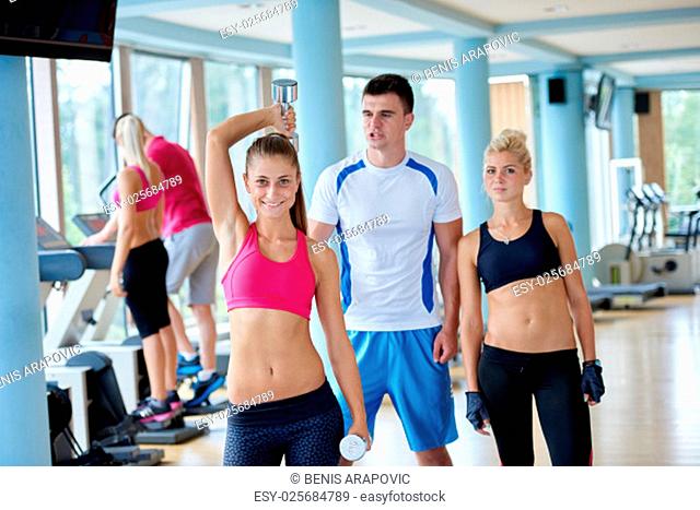 group portrait of healthy and fit young people in fitness gym