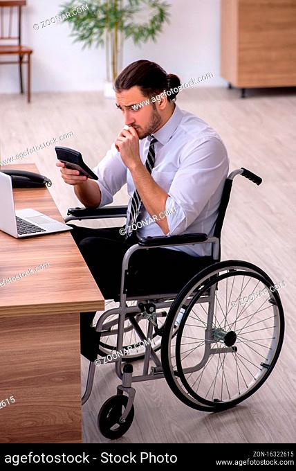 Young disabled employee suffering at the workplace