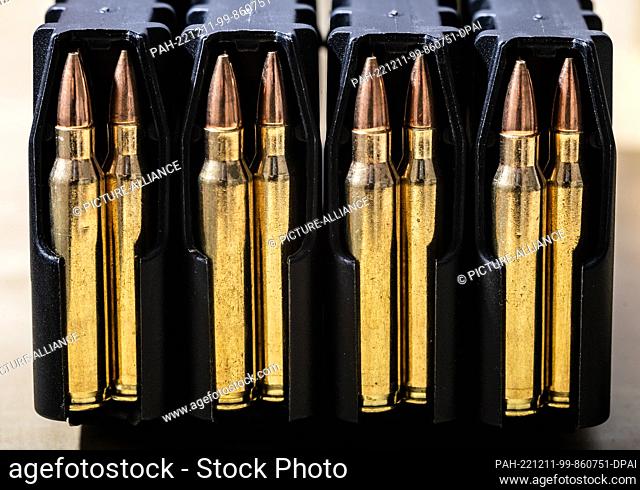 SYMBOL - 10 December 2022, Baden-Wuerttemberg, Rottweil: 223 caliber Remington cartridges are seen in magazines on a table of a sports shooter
