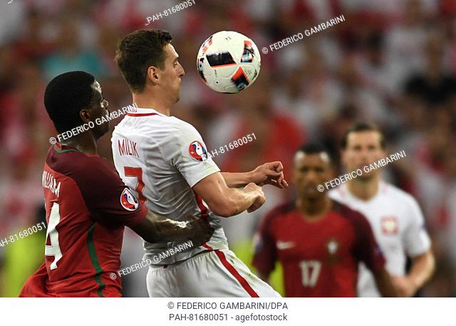 Arkadiusz Milik (2-L) of Poland and William Carvalho (L) of Portugal vie for the ball during the UEFA EURO 2016 quarter final soccer match between Poland and...