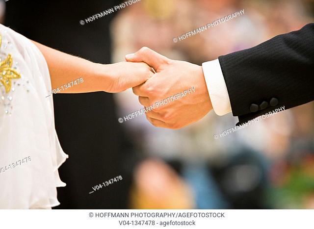 Couple holding hands at a dancing competition, Germany, Europe
