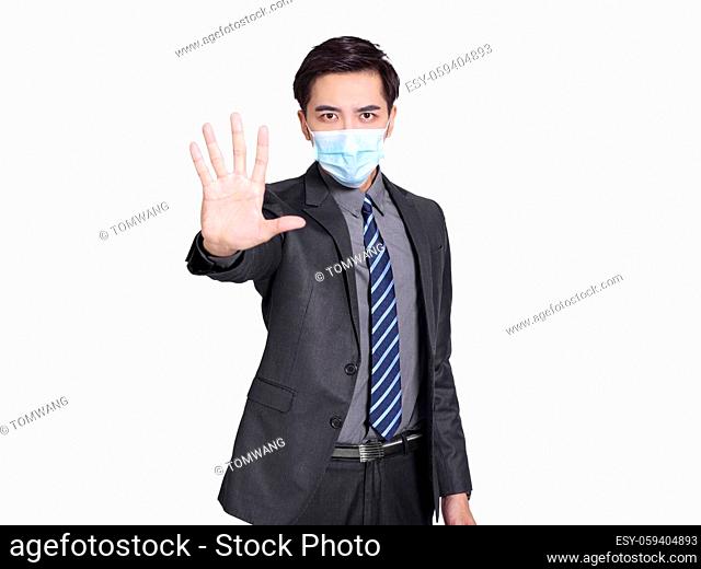 young businessman wearing medical mask for protection, made refusal gesture and said no, calling for close contact during covid-19