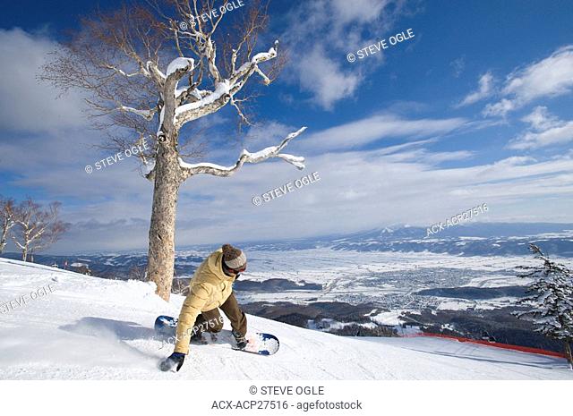 A Japanese snowboarder makes a turn at Furano resort, Hokkaido, Japan