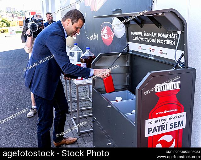 Jiri Hajek, Director of Orlen Unipetrol gives plastic bottle with used cooking oils to into box during the press conference on launch of pilot project for...