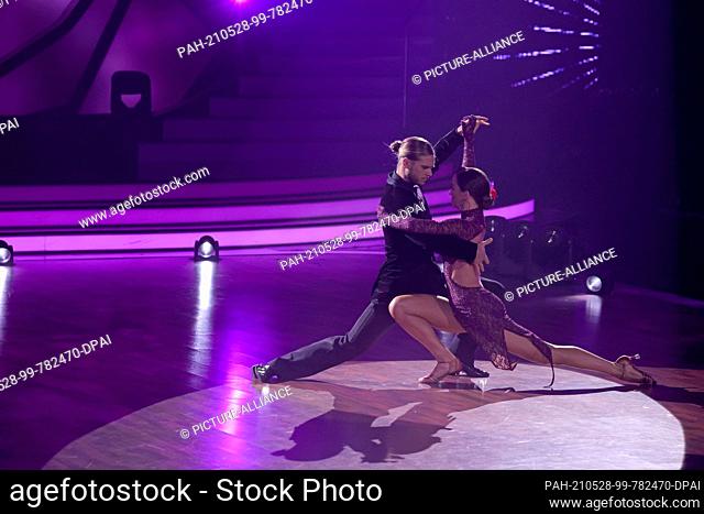 28 May 2021, North Rhine-Westphalia, Cologne: Rúrik Gíslason and Renata Lusin dance a tango to the song ""Let's Dance"" in the final of the 14th season of the...