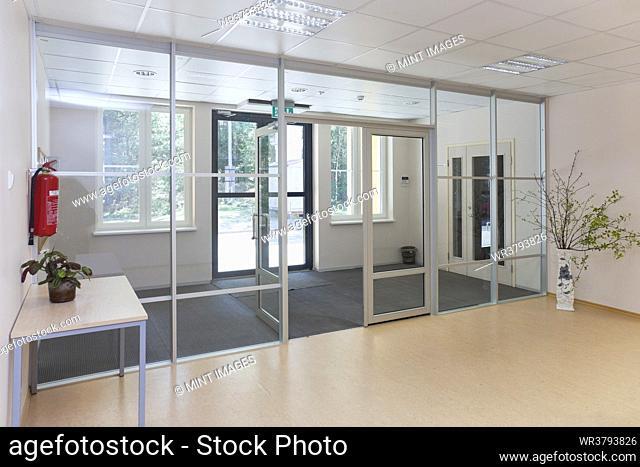 An empty modern school, wide glass doors and entrance hall