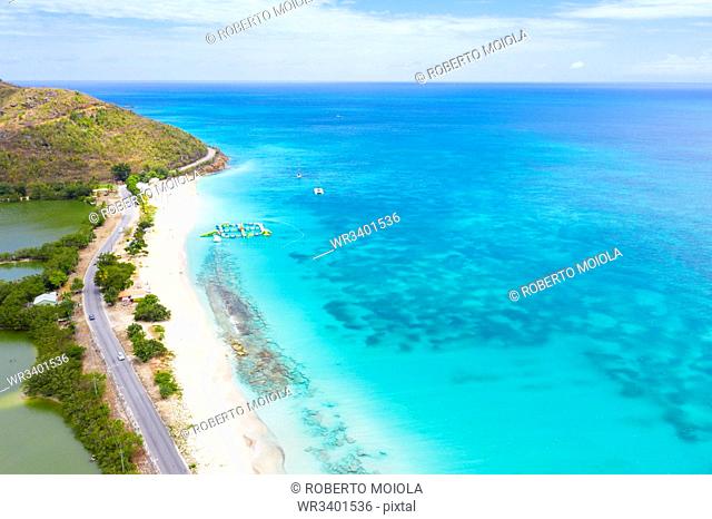 Aerial view by drone of coastal road beside white sand beach, Caribbean, Antilles, West Indies, Caribbean, Central America