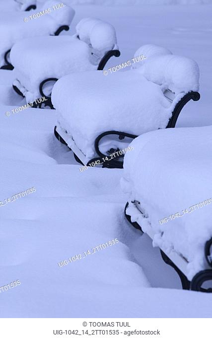 Benches covered with thick snow