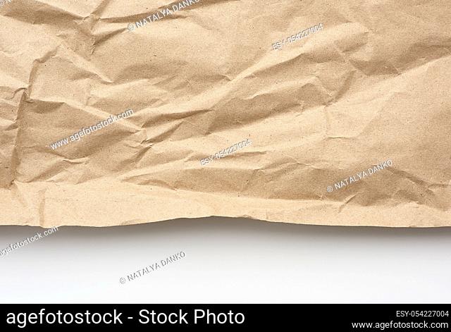 piece of crumpled blank sheet of brown wrapping paper. Grunge texture. kraft paper texture