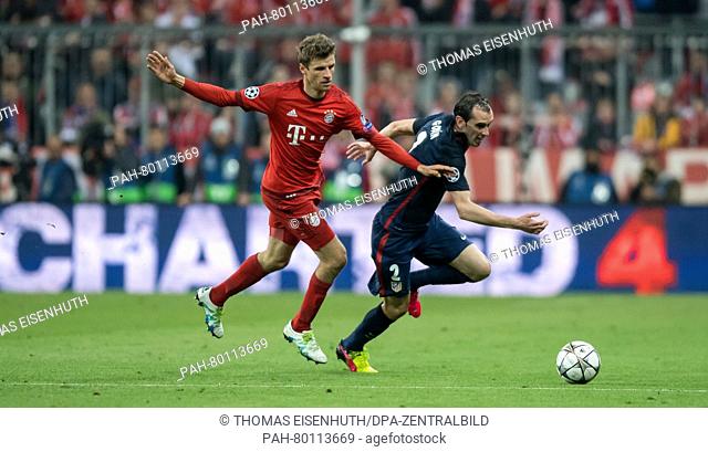 Bayern Munich's Thomas Müller and Madrid's Diego Godin in action during the UEFA Champions League semi final soccer match FC Bayern Munich vs Atletico Madrid in...