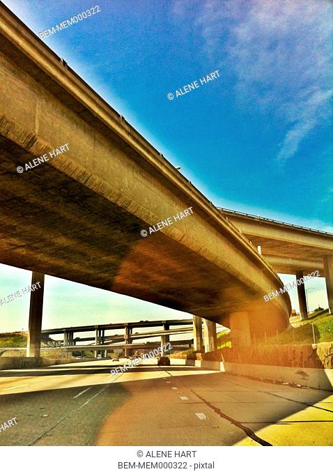 Freeway overpass against blue sky, Los Angeles, California, United States