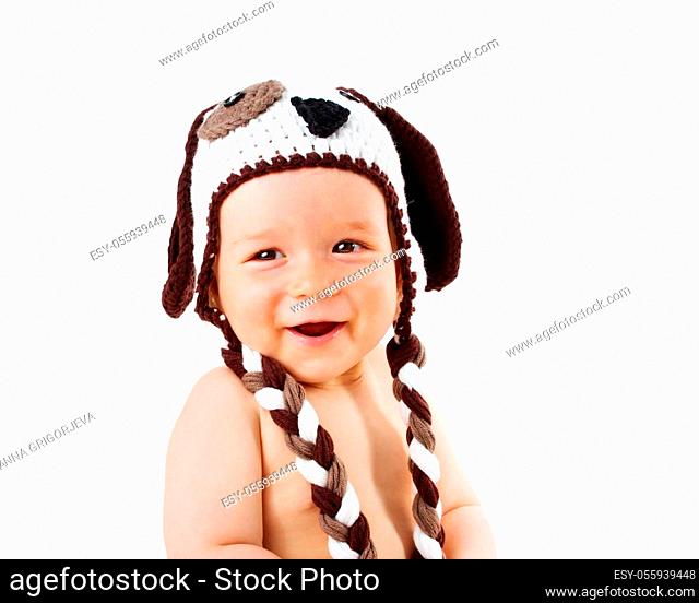 happy baby in dog hat smiling isolated on white background