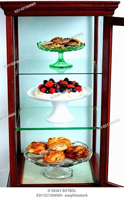 Shelf decorated by delicious desserts