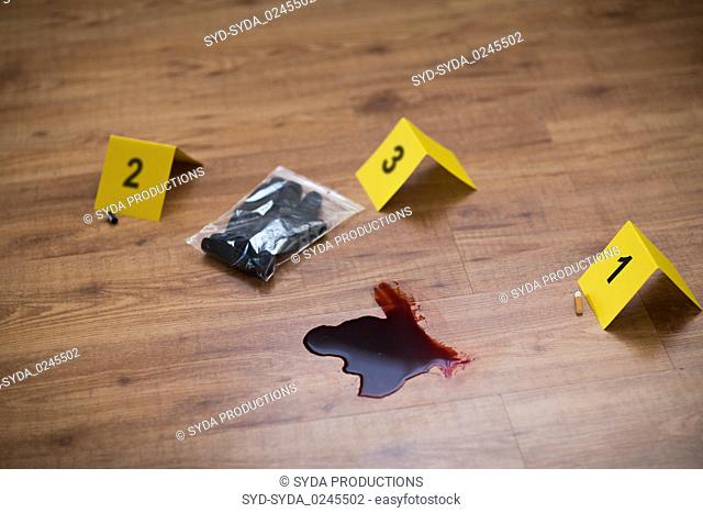 knife in blood and evidence marker at crime scene