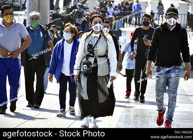 MEXICO CITY, MEXICO - DECEMBER 8: A Faithful wears a protective mask with the stamped picture of Virgin of Guadalupe while visit the Basilica of Guadalupe...