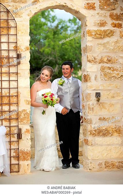 USA, Texas, Bride and groom with bridal bouquet, smiling