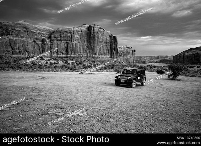 Wrangler Jeep driving around the Artist Point. Monument Valley Navajo Tribal Park, Utah and Arizona, USA