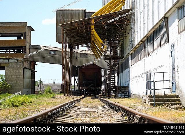 RUSSIA, ZAPOROZHYE REGION - MAY 16, 2023: Railroad cars are loaded with wheat at a grain storage facility in the village of Akimovka, Melitopol District