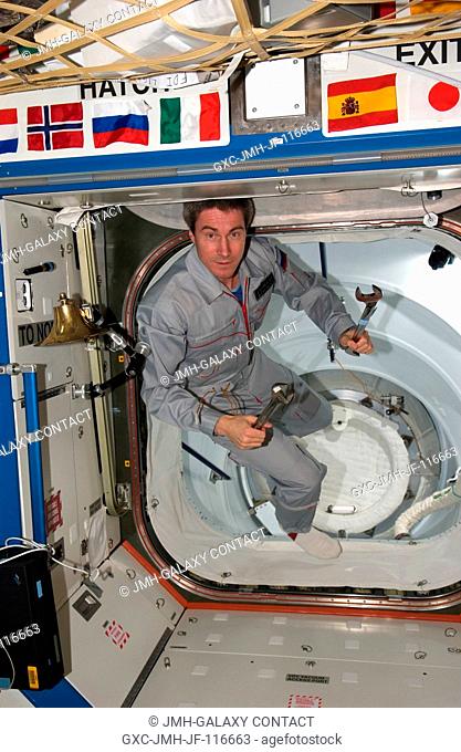Cosmonaut Sergei K. Krikalev, Expedition 11 commander representing Russia's Federal Space Agency, holds tools while floating into the Destiny laboratory on the...