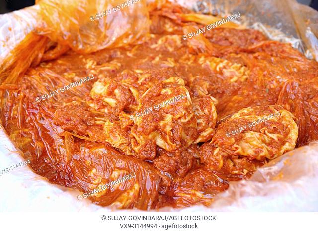 Close shot of spiced up honum with tomato sauce, a uzbek regional non-vegetarian dish