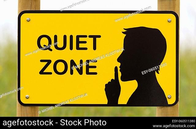 Quiet zone sign, yellow with a black silhouette