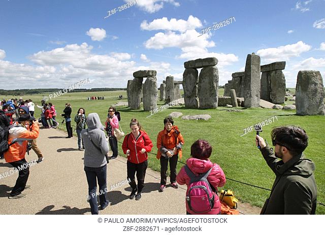 Tourists are seen at the ancient neolithic monument of Stonehenge in Wiltshire, England. Stonehenge is prehistoric monument in Europe and UNESCO World Heritage...