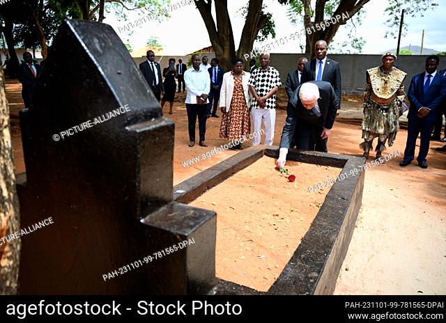 01 November 2023, Tanzania, Songea: German President Frank-Walter Steinmeier lays a rose together with descendants of the heroes of the Maji Maji War at the...