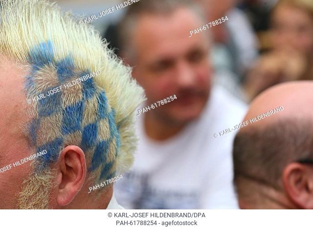 The hair of a visitor features a blue-white rhombic pattern similar to the Bavarian state flag at the 182nd Oktoberfest in Munich, Germany, 20 September 2015