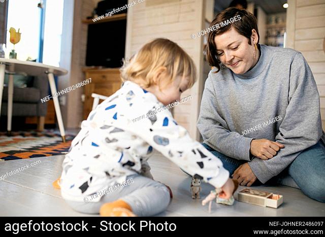 Mother playing with daughter at home