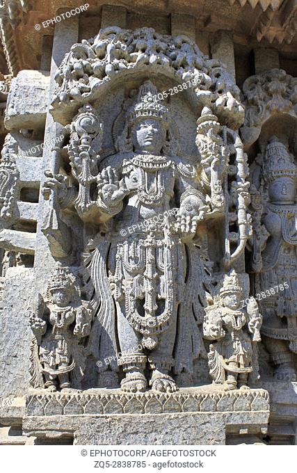 Close up of deity sculpture under eves on shrine outer wall in the Chennakesava Temple, Hoysala Architecture at Somnathpur, Karnataka, India
