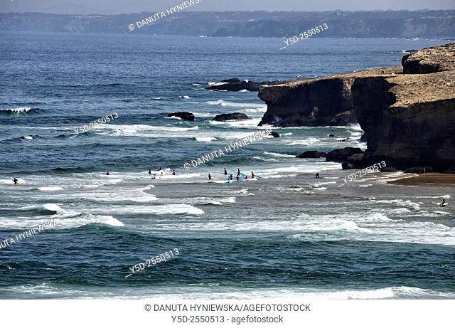 Europe, Portugal, Algarve, Faro district, Azjezur, Costa Vicentina, Monte Clérigo beach, Praia do Monte Clérigo, surfers in waters of Atlantic Ocean