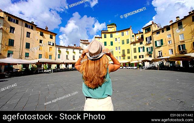 Travel in Italy. Panoramic banner view of young tourist woman visiting the historic city of Lucca in Tuscany, Italy