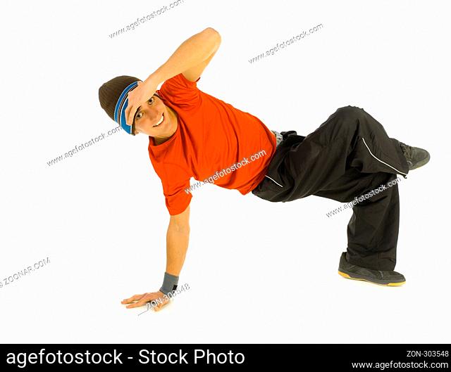 Young, happy bboy holding up on hands and head. Looking at camera and smiling. Isolated on white in studio. Side view, whole body