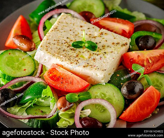 Greek salad with fresh vegetables, feta cheese and black olives. Macro, close up