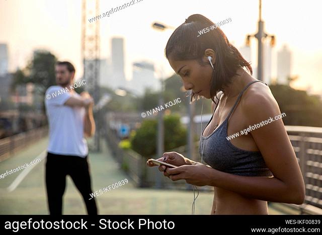 Woman listening to music through smart phone