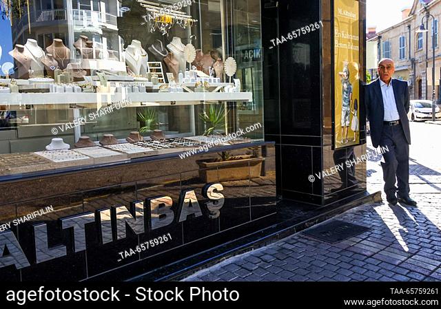 CYPRUS, NICOSIA - DECEMBER 14, 2023: A man stands next to a shopfront. The Turkish Republic of Northern Cyprus is a de facto state declared independent by...