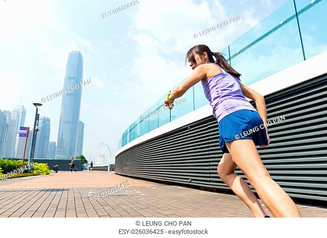 Woman check the record when running in city