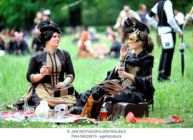 Two ladies sit in a park at the 'Steam Punk' picnic during the Wave-Gotik-Treffen (WGT) festival in Leipzig, Germany, 23 May 2015