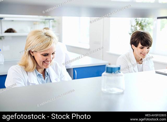 Smiling researcher working in laboratory