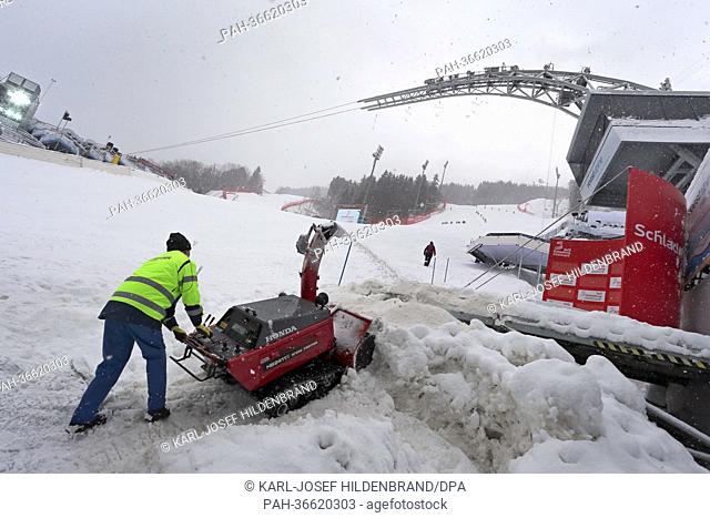 A helper removes snow out of the finish area in Schladming, Austria, 03 February 2013. The Alpine Skiing World Championships in Schladming run from 04 to 17...