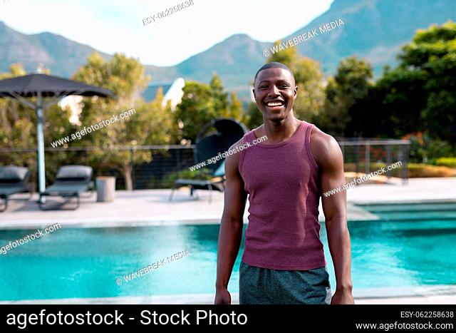 Portrait of happy african american man smiling in garden