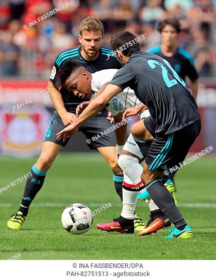 Leverkusen's Wendell and Real's Asier Illarramendi and Joseba Zaldua (r) in action during the soccer test match between Bayer Leverkusen and Real Sociedad at...
