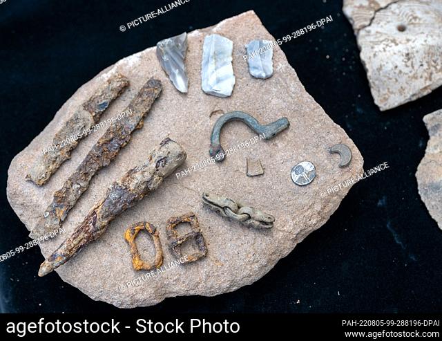 05 August 2022, Saxony-Anhalt, Nebra: Finds from the excavation on the site of the medieval Altenburg near Nebra, including a coin, a fibula or a knife